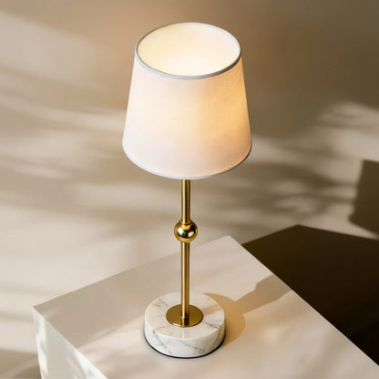 A clutter-free entryway console table featuring the brass-finished and marble cordless lamp with touch-sensitive dimming, objectively adapting to modern lighting needs.