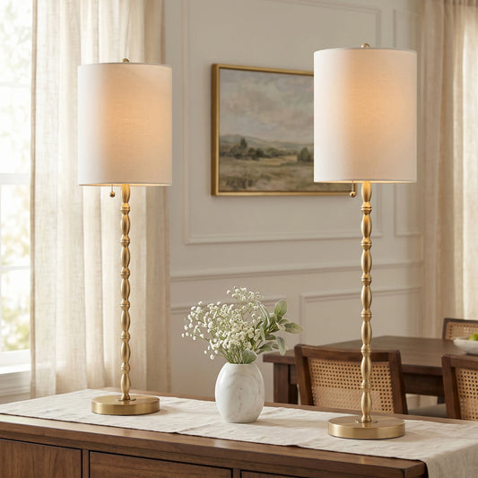Set of two 28.5-inch tall modern brass-finished buffet lamps standing elegantly on a dining room sideboard.