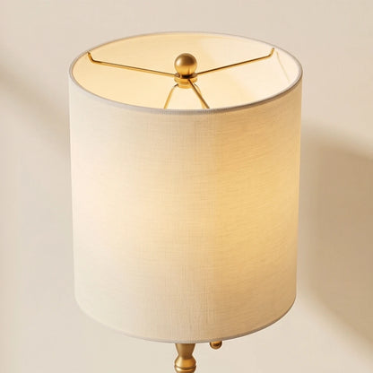 A symmetrical pair of tall brass buffet lamps framing an entryway console mirror, showcasing architectural elegance and sophisticated interior staging.