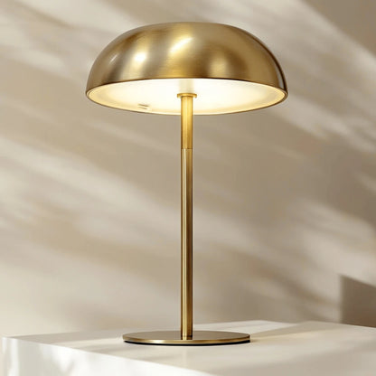 Sculptural cordless mushroom lamp with a touch-sensitive base for stepless dimming, casting an ambient glow for a sophisticated home atmosphere.
