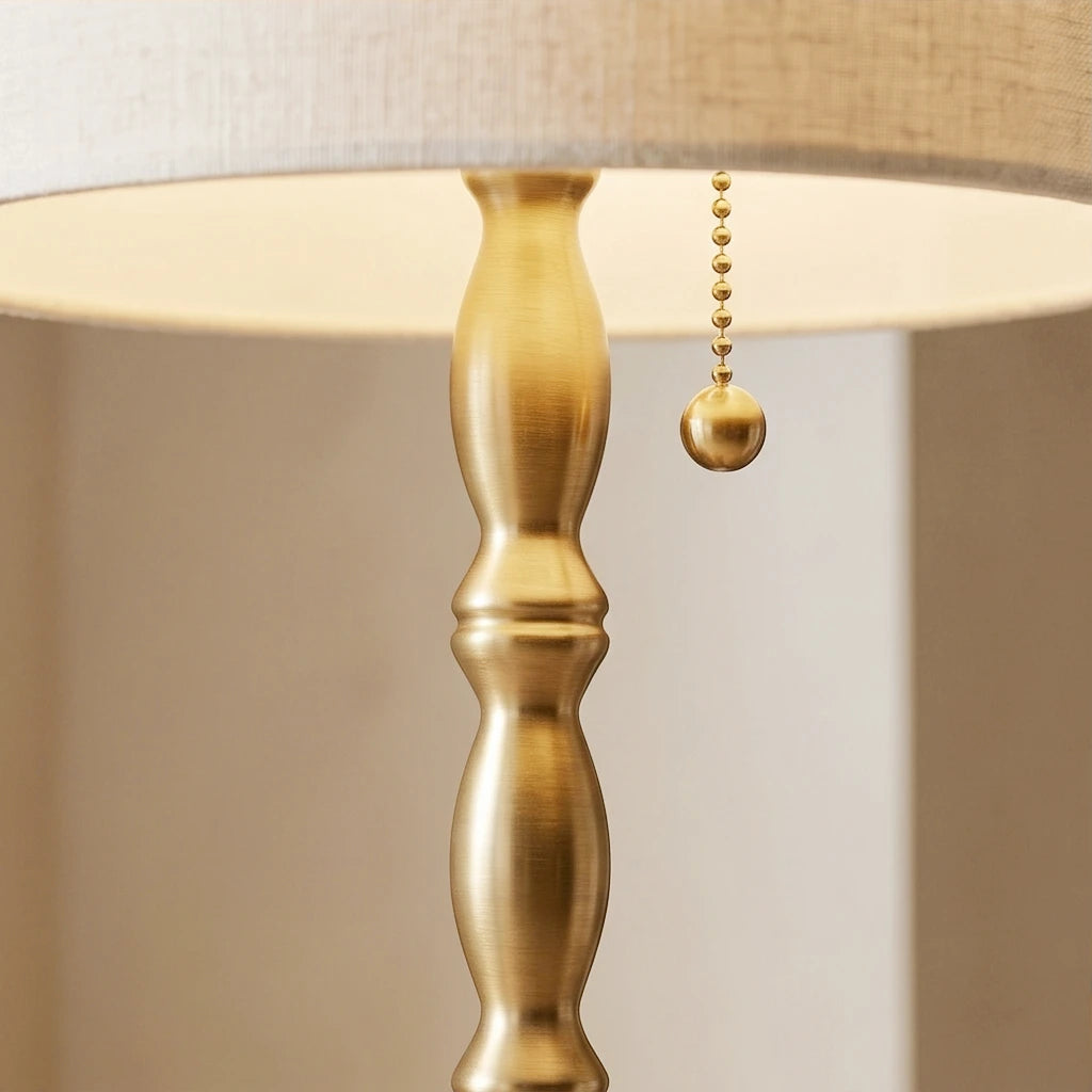 Close-up of the sophisticated brushed brass electroplated candlestick body and classic metal pull-chain switch.