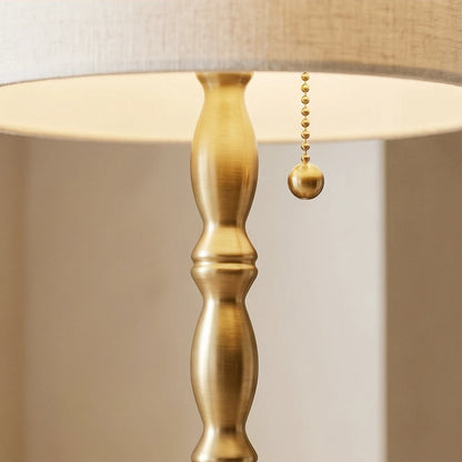 Close-up of the sophisticated brushed brass electroplated candlestick body and classic metal pull-chain switch.